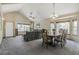 Open concept living and dining area with vaulted ceilings and large windows for ample light at 5457 S Valdai St, Aurora, CO 80015
