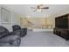 Inviting living room with plush seating, carpet, staircase access and soft natural lighting at 5457 S Valdai St, Aurora, CO 80015