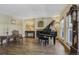 Bright living room with hardwood floors, fireplace and grand piano at 5457 S Valdai St, Aurora, CO 80015