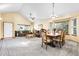 Spacious living room and dining area featuring an open floor plan with carpet flooring and natural light at 5457 S Valdai St, Aurora, CO 80015