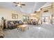 Open-concept living room with plush carpeting, a dining area, and a staircase to the upper level at 5457 S Valdai St, Aurora, CO 80015