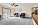 Inviting living room with natural light, neutral carpeting, and access to outdoor space at 5457 S Valdai St, Aurora, CO 80015