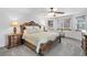 Main bedroom features a decorative bed, two side tables with lamps, and ample natural light at 5457 S Valdai St, Aurora, CO 80015