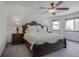 Comfortable main bedroom with a large bed, a ceiling fan, two windows, and bedside lamps at 5457 S Valdai St, Aurora, CO 80015