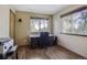 Home office with two windows, hardwood floors, a dark wood desk, and natural light at 5457 S Valdai St, Aurora, CO 80015