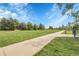Scenic park view featuring expansive green space, walking path, mature trees, and sports area under a blue sky at 5457 S Valdai St, Aurora, CO 80015