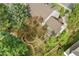 Aerial view of home with lush landscaping, stone patio, winding walking path, and mature trees at 7770 S Ivy Way, Centennial, CO 80112