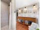 Elegant bathroom featuring double sinks, a separate shower and warm lighting at 7770 S Ivy Way, Centennial, CO 80112
