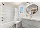Bright bathroom with shiplap walls, patterned tile floors, and modern fixtures at 7770 S Ivy Way, Centennial, CO 80112