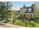 Beautifully landscaped front yard with a charming brick home and mature trees at 7770 S Ivy Way, Centennial, CO 80112