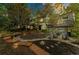 Beautiful home exterior featuring a large tree, landscape lighting and stone patio at 7770 S Ivy Way, Centennial, CO 80112