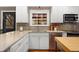 Kitchen features stainless appliances, quartz countertops, tile backsplash, and white cabinets at 7770 S Ivy Way, Centennial, CO 80112