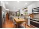 Bright kitchen features stainless appliances, tile backsplash, an island, and hardwood floors at 7770 S Ivy Way, Centennial, CO 80112