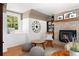 Inviting living room features a brick fireplace, layered lighting, and comfortable seating at 7770 S Ivy Way, Centennial, CO 80112