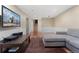 Spacious living room with hardwood floors, TV, and comfortable gray sectional sofa at 7770 S Ivy Way, Centennial, CO 80112