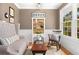 Inviting living room has comfortable seating, bright light, and a built-in bookcase at 7770 S Ivy Way, Centennial, CO 80112