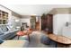 Bright living room has a comfortable sofa, coffee table, and access to other rooms at 7770 S Ivy Way, Centennial, CO 80112