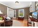 Comfortable home office with built-in bookshelves, hardwood floors, and large windows at 7770 S Ivy Way, Centennial, CO 80112