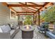 Cozy covered patio featuring a fire pit surrounded by comfortable seating at 7770 S Ivy Way, Centennial, CO 80112