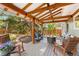 Inviting outdoor patio with a fire pit, rocking chairs, and lush greenery at 7770 S Ivy Way, Centennial, CO 80112