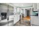 Bright kitchen featuring stainless steel appliances and light wood flooring at 2594 S Tennyson Way, Denver, CO 80219