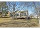 Back of house featuring large windows, wooden deck, and yard with tree at 10340 Winona Ct, Westminster, CO 80031