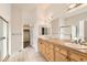 Bathroom featuring double sinks with granite countertops and a separate shower and closet at 10340 Winona Ct, Westminster, CO 80031