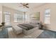 Spacious main bedroom features a ceiling fan, natural light, and space for a sitting area at 10340 Winona Ct, Westminster, CO 80031