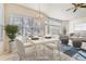 Bright dining area with a modern table, seating and lots of natural light from large windows at 10340 Winona Ct, Westminster, CO 80031