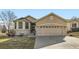 Charming home featuring a two-car garage, stone accents, manicured lawn, and inviting front entrance at 10340 Winona Ct, Westminster, CO 80031