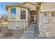 Inviting front entrance with stone accents, manicured landscaping, and clear address signage at 10340 Winona Ct, Westminster, CO 80031