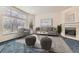 Staged living room featuring a neutral color palette, fireplace, and large windows at 10340 Winona Ct, Westminster, CO 80031