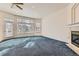 Sunlit living room with ample windows, fireplace, and neutral walls at 10340 Winona Ct, Westminster, CO 80031