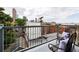 Relaxing balcony seating area with city skyline view and wrought iron railing at 1747 N Washington St # C303, Denver, CO 80203