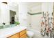 Well-lit bathroom with a tiled shower, bathtub, and a traditional vanity at 1747 N Washington St # C303, Denver, CO 80203