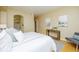 Bedroom with a view of the ensuite bathroom, hardwood floors, neutral walls and plenty of natural light at 1747 N Washington St # C303, Denver, CO 80203
