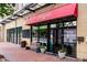 Yoga studio entrance featuring a red awning, bench, and ample natural light at 1747 N Washington St # C303, Denver, CO 80203