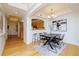 Elegant dining room features modern lighting, an open floor plan, and hardwood floors at 1747 N Washington St # C303, Denver, CO 80203