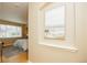 Hallway view showing an alcove with painting and the view of a bedroom with lots of natural light at 1747 N Washington St # C303, Denver, CO 80203