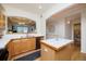 Bright kitchen features wood cabinets, tile countertops, stainless steel appliances, and a view to the dining room at 1747 N Washington St # C303, Denver, CO 80203
