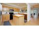 Functional kitchen featuring stainless steel appliances, a center island, and wood cabinets at 1747 N Washington St # C303, Denver, CO 80203
