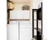 Functional laundry room with washer, dryer, storage cabinets and shelving at 1747 N Washington St # C303, Denver, CO 80203