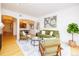 Open living area with a green sofa, modern furniture, art, and lots of natural light at 1747 N Washington St # C303, Denver, CO 80203