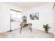 Office with a large window, modern desk, decoratives, and light colored carpeted floors at 1747 N Washington St # C303, Denver, CO 80203