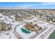 Winter aerial of townhomes, community pool, and mountains in background offering desirable neighborhood amenities at 15550 W 64Th Pl # D, Arvada, CO 80007