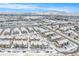 Aerial view of townhome community covered in snow with views of the surrounding landscape at 15550 W 64Th Pl # D, Arvada, CO 80007