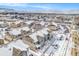 Aerial view of a snowy residential community with mountain views at 15550 W 64Th Pl # D, Arvada, CO 80007