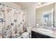 Bathroom with a nautical themed shower curtain and vanity with granite counter at 15550 W 64Th Pl # D, Arvada, CO 80007