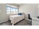 Cozy bedroom with a twin bed, blue pillows, gray carpet and a bright window view at 15550 W 64Th Pl # D, Arvada, CO 80007