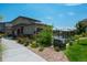 Exterior of the community pool house with landscaping, walkway and a glimpse of a pool at 15550 W 64Th Pl # D, Arvada, CO 80007